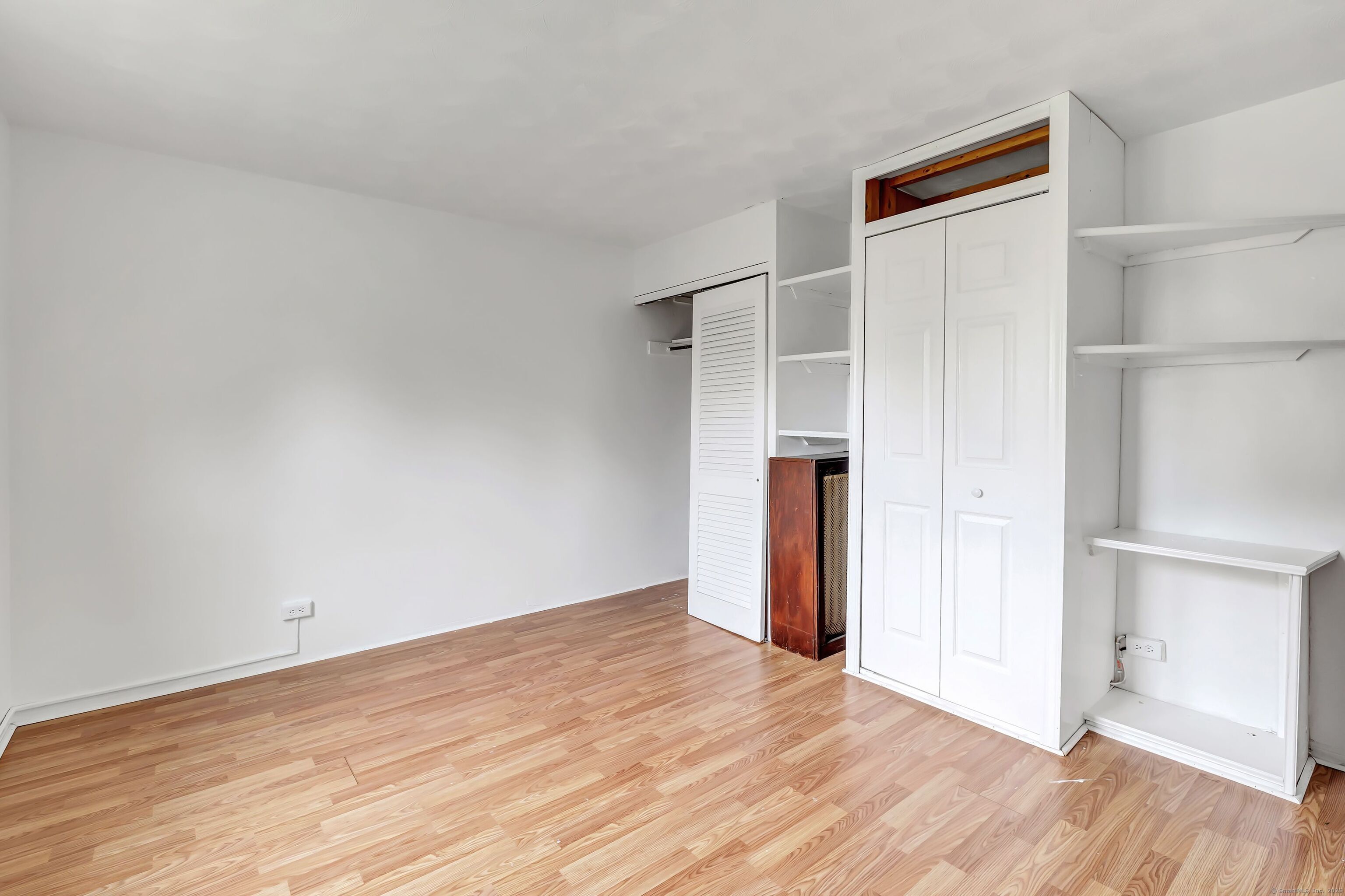 367 D Building 5 Granfield Avenue Bridgeport, CT 06610 - Photo 13 of 13 an empty room with wooden floor and closet