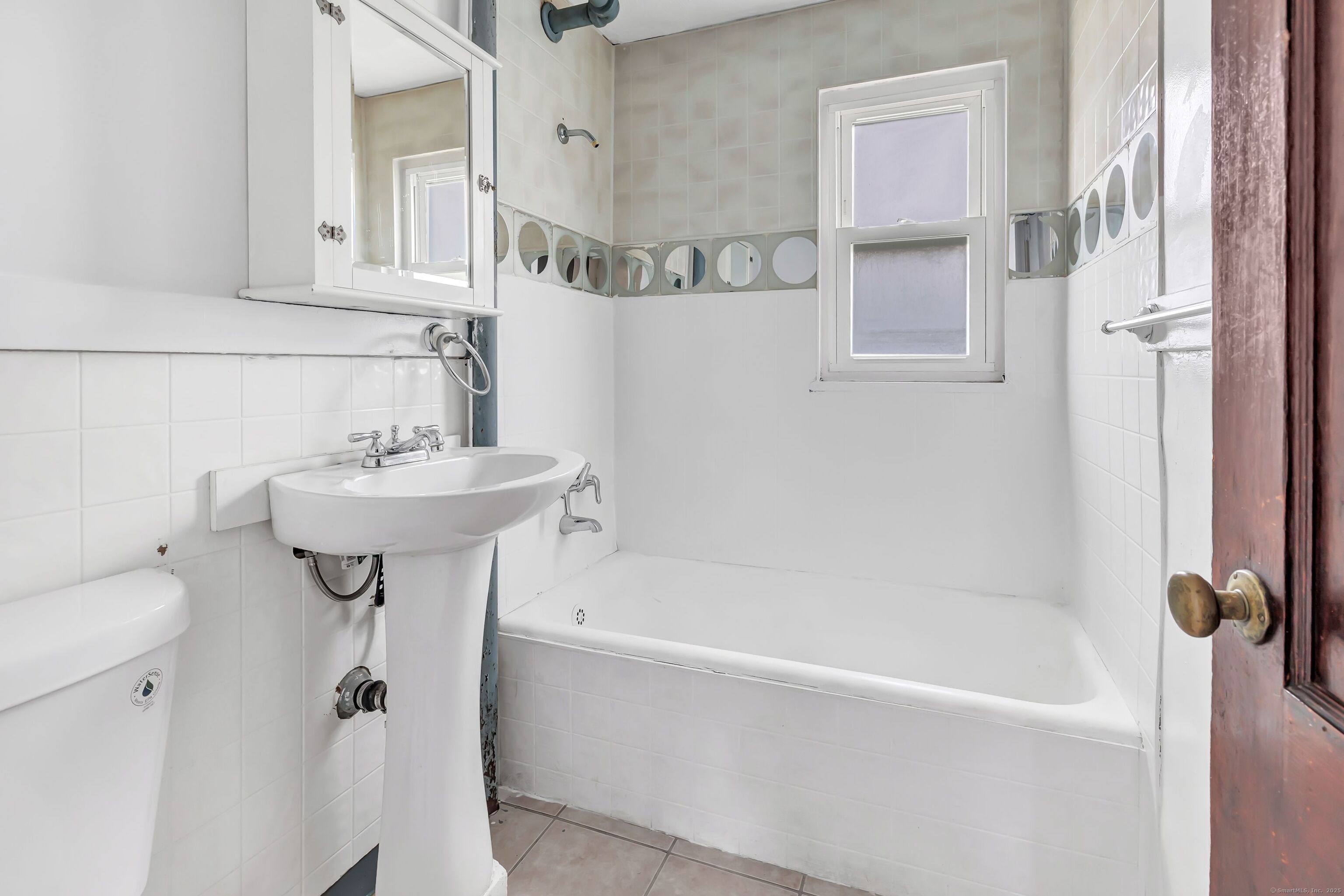 367 D Building 5 Granfield Avenue Bridgeport, CT 06610 - Photo 10 of 13 a bathroom with a sink a mirror toilet and bathtub