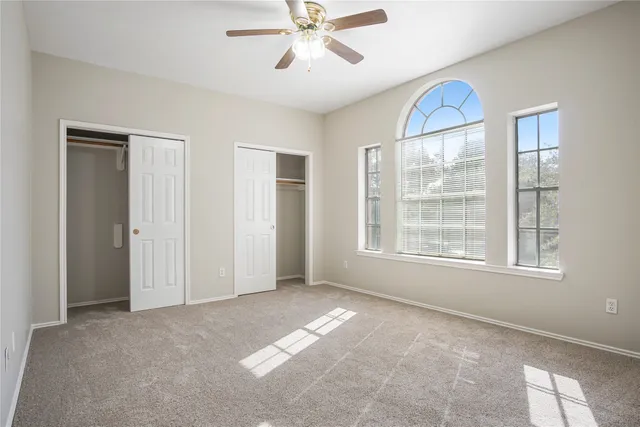 a view of a livingroom with a ceiling fan and window