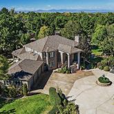 an aerial view of a house with yard patio and outdoor seating