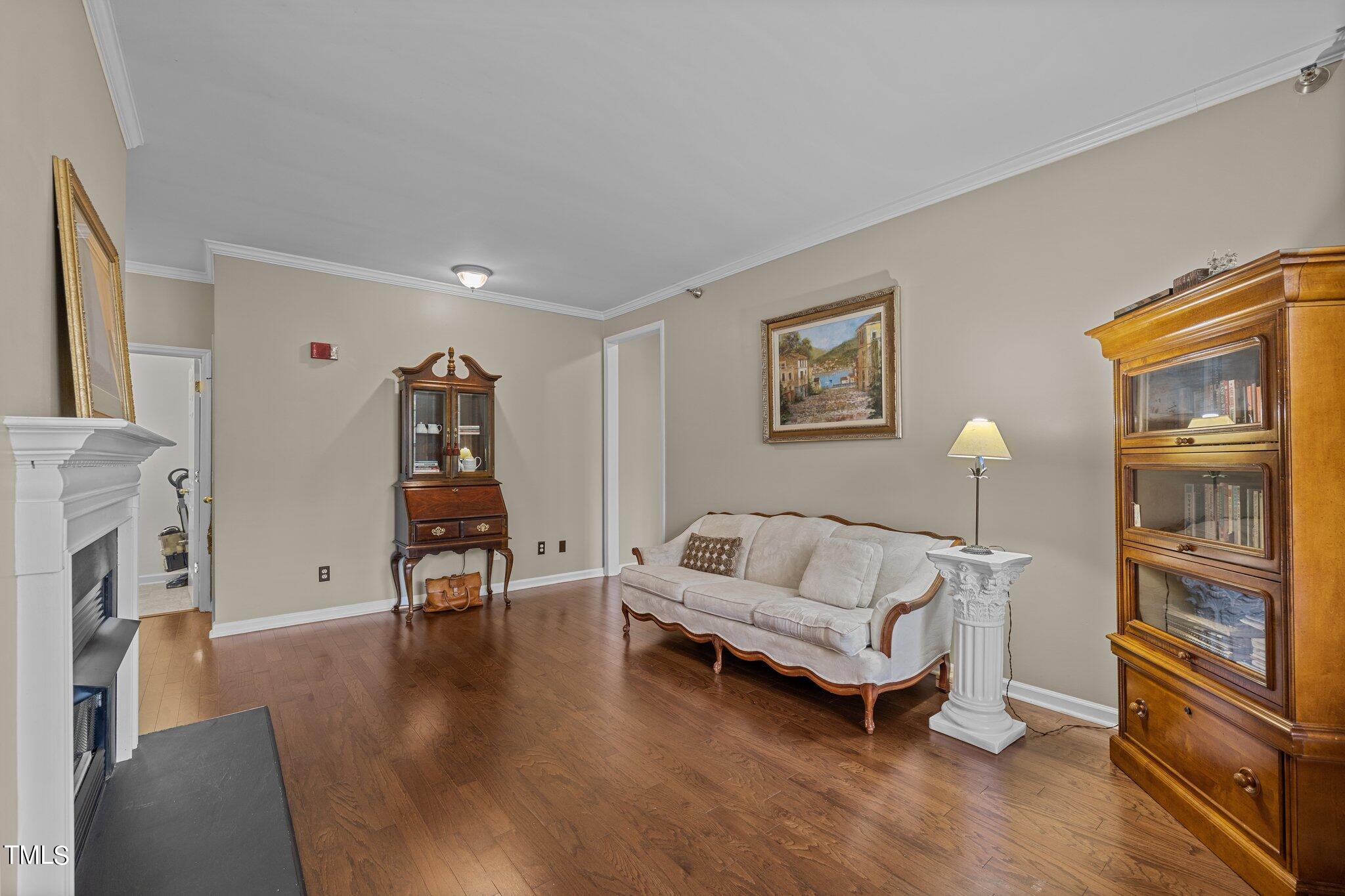 1710 Tiffany Bay Court, Unit 301 Raleigh, NC 27609 - Photo 11 of 36 a living room with furniture and a fireplace