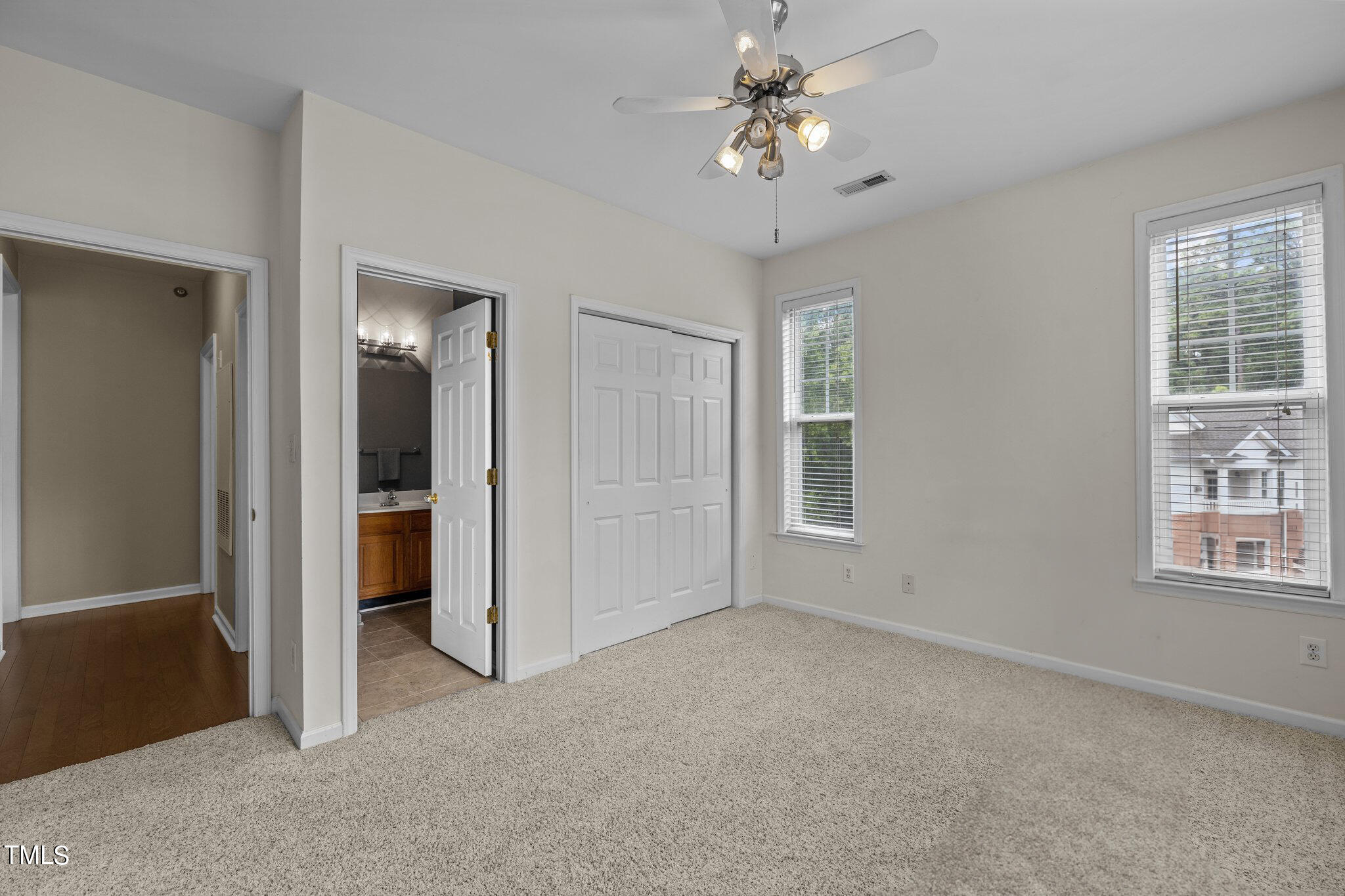 1710 Tiffany Bay Court, Unit 301 Raleigh, NC 27609 - Photo 18 of 36 an empty room with windows and closet