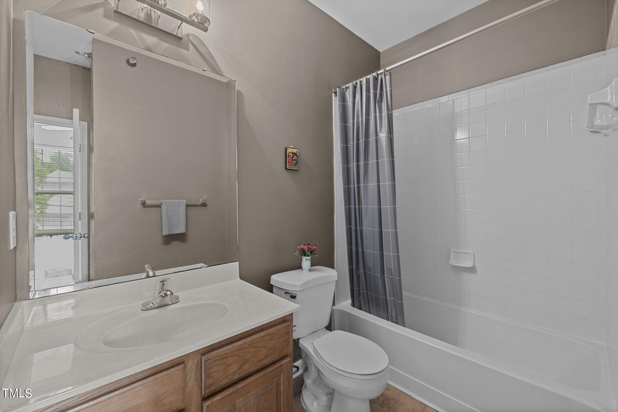 1710 Tiffany Bay Court, Unit 301 Raleigh, NC 27609 - Photo 19 of 36 a bathroom with a sink toilet and shower