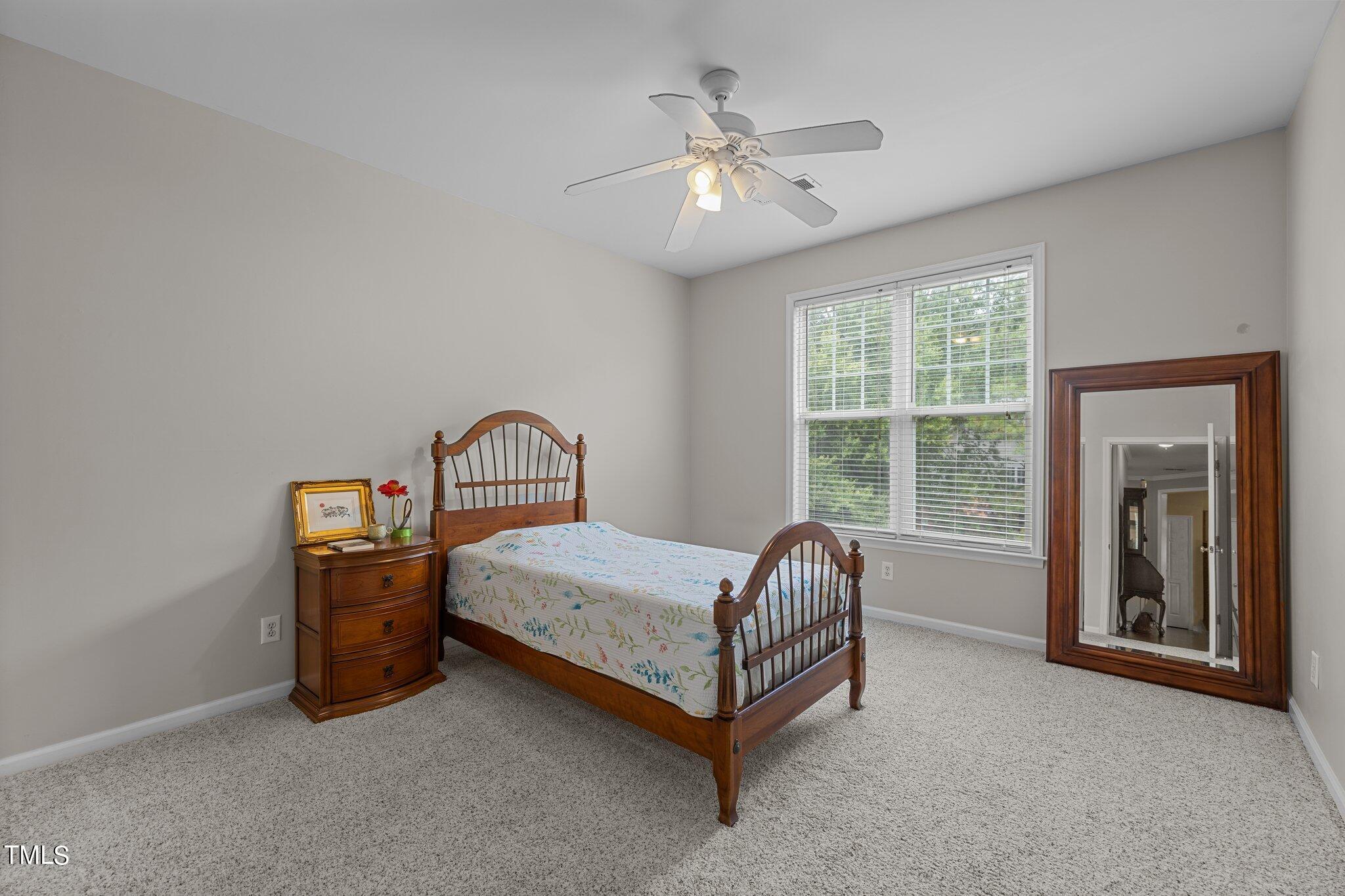 1710 Tiffany Bay Court, Unit 301 Raleigh, NC 27609 - Photo 20 of 36 a bed sitting in a spacious bedroom next to a window