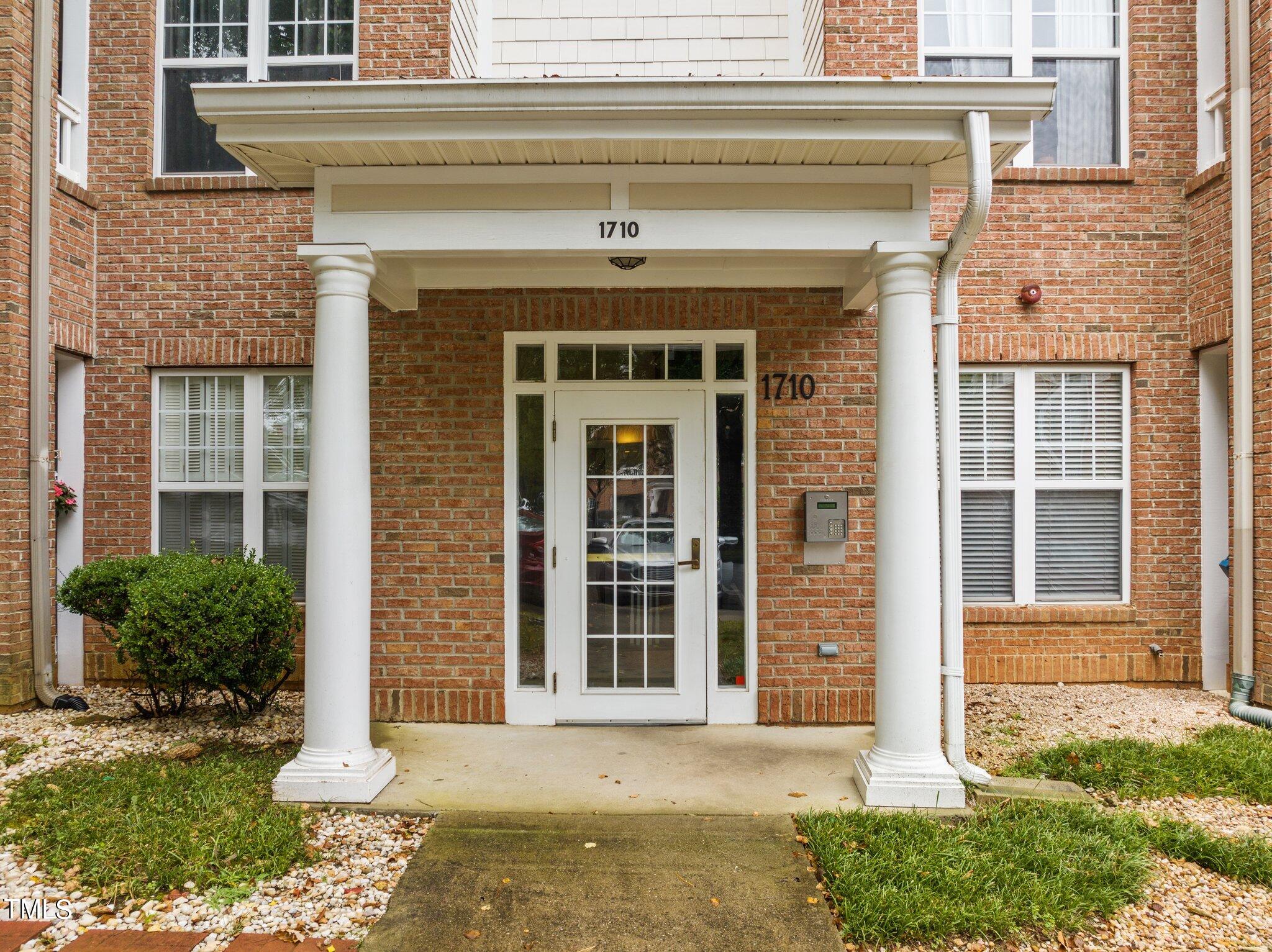 1710 Tiffany Bay Court, Unit 301 Raleigh, NC 27609 - Photo 2 of 36 front view of a house with a yard
