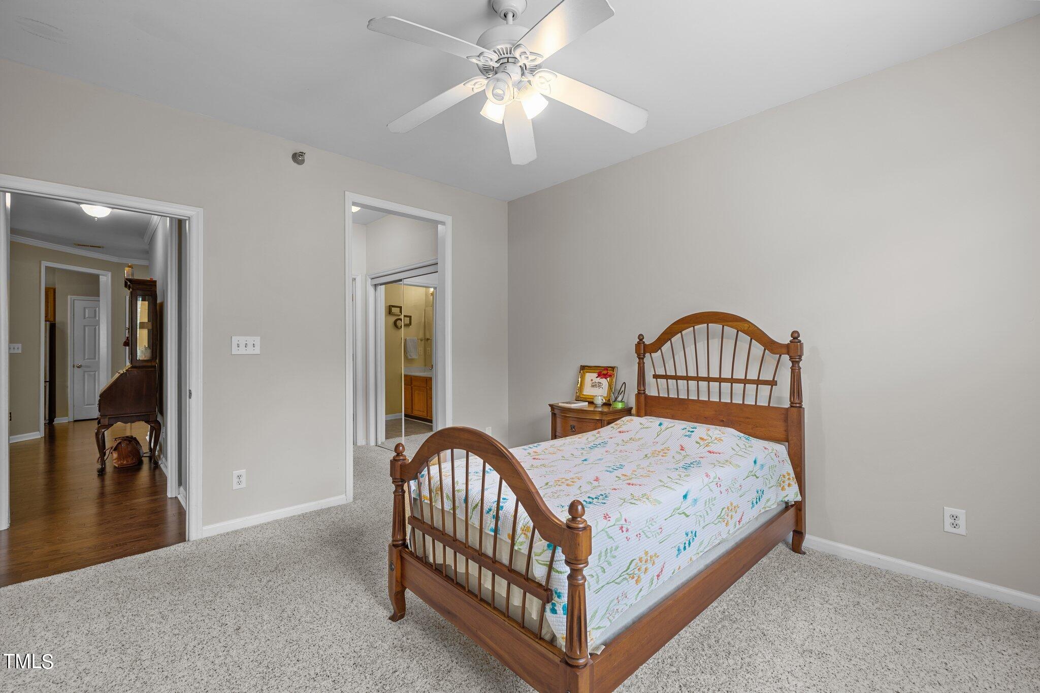 1710 Tiffany Bay Court, Unit 301 Raleigh, NC 27609 - Photo 21 of 36 a bedroom with a bed and a chandelier