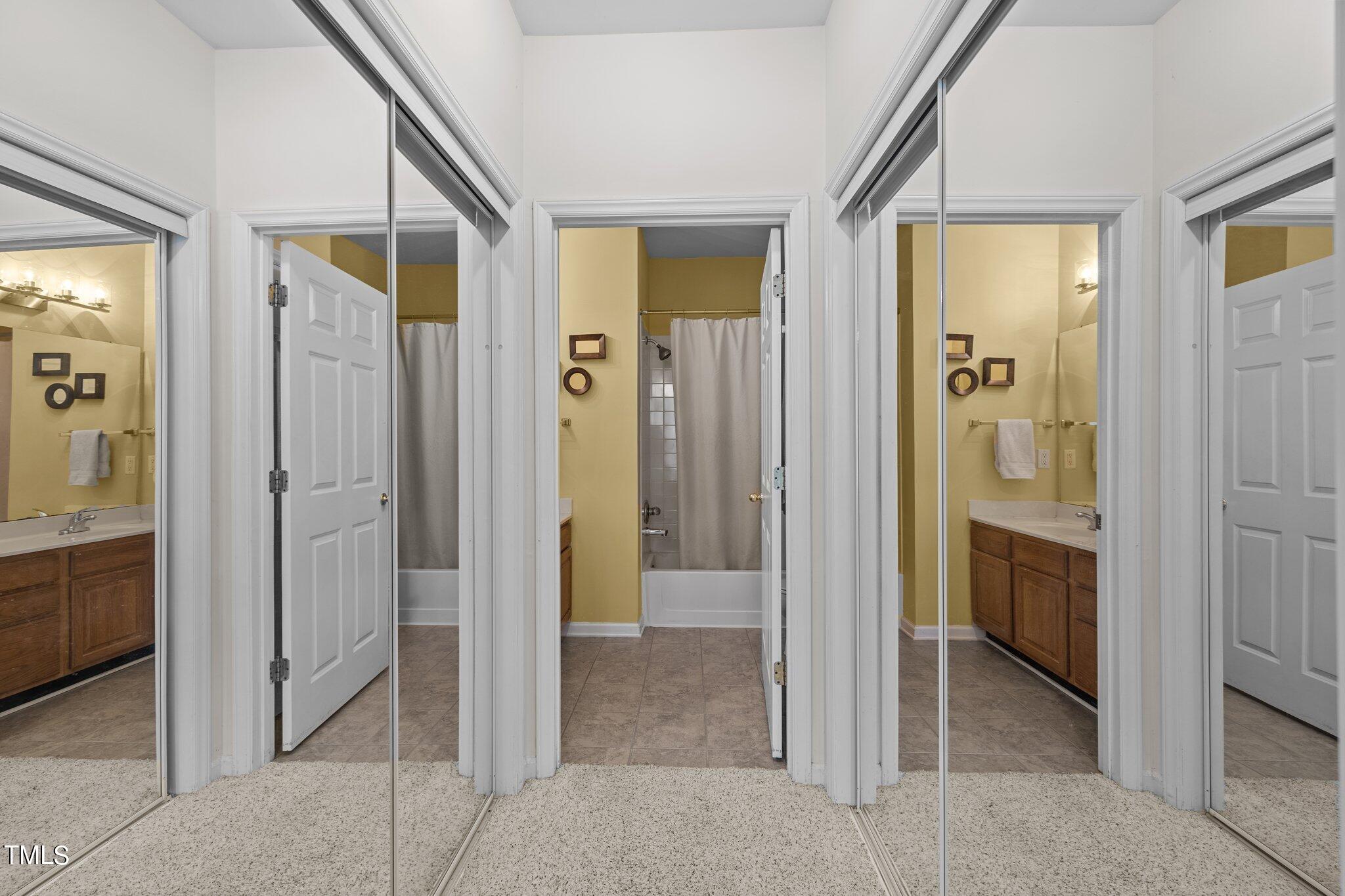 1710 Tiffany Bay Court, Unit 301 Raleigh, NC 27609 - Photo 22 of 36 a view of a bathroom with a shower and a sink