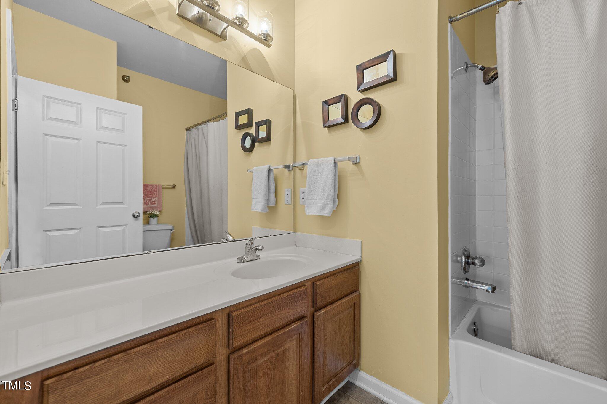 1710 Tiffany Bay Court, Unit 301 Raleigh, NC 27609 - Photo 23 of 36 a bathroom with a sink and a mirror