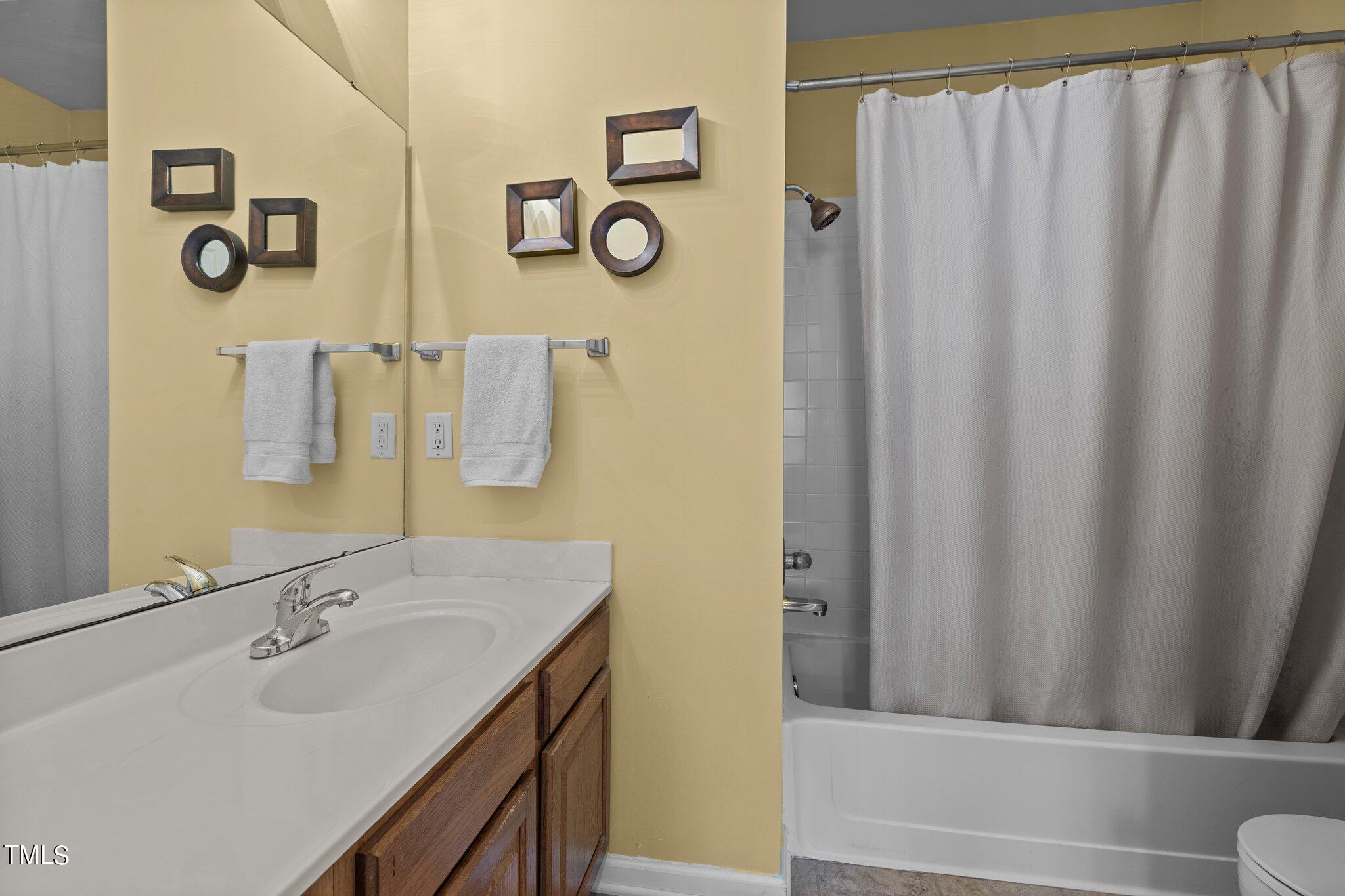 1710 Tiffany Bay Court, Unit 301 Raleigh, NC 27609 - Photo 24 of 36 a bathroom with a sink and a mirror