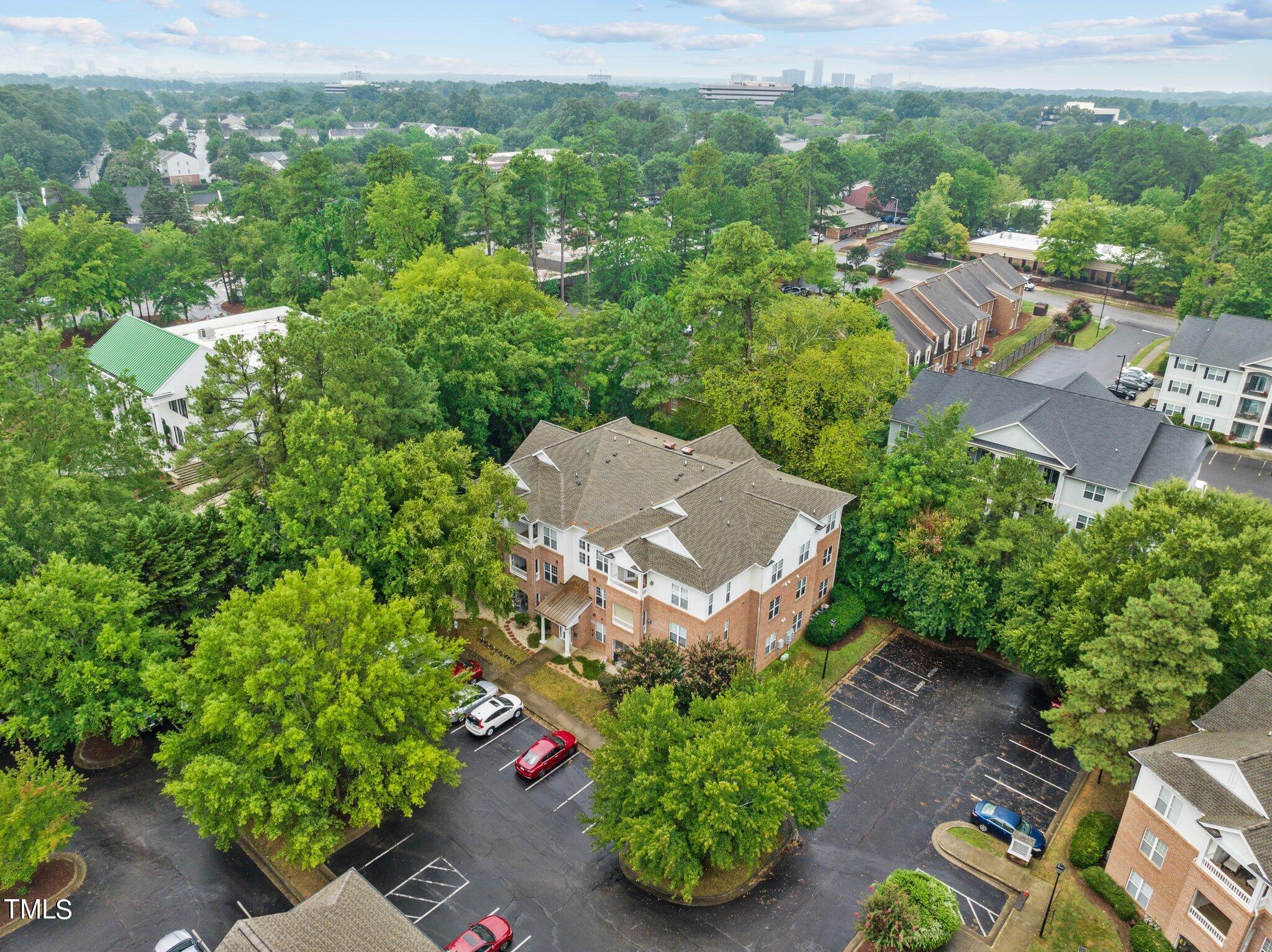 1710 Tiffany Bay Court, Unit 301 Raleigh, NC 27609 - Photo 33 of 36 an aerial view of a house with a yard and lake view
