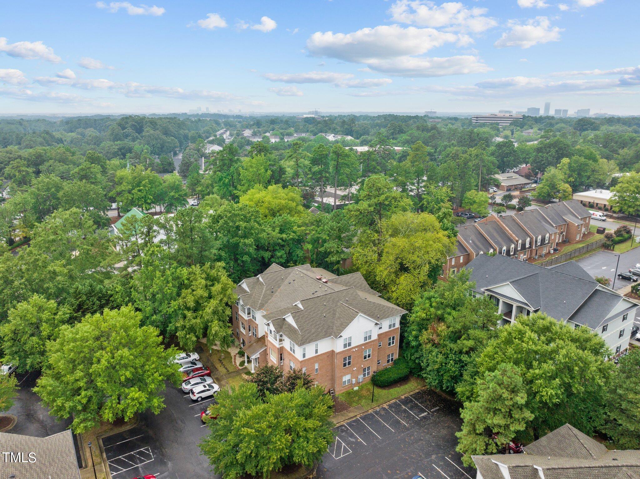1710 Tiffany Bay Court, Unit 301 Raleigh, NC 27609 - Photo 34 of 36 a view of a house with a yard and pool
