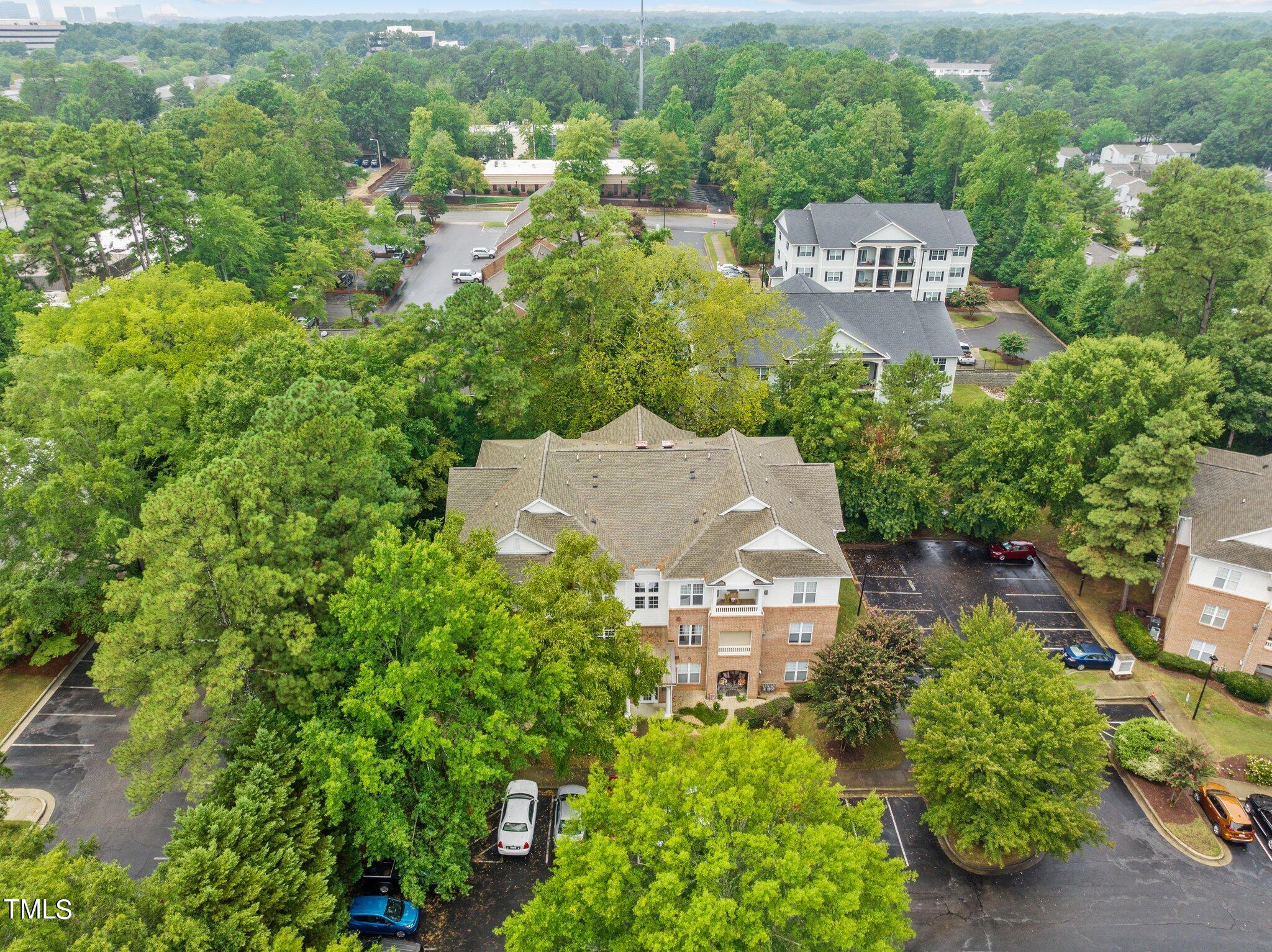1710 Tiffany Bay Court, Unit 301 Raleigh, NC 27609 - Photo 35 of 36 an aerial view of a house with a yard and lake view