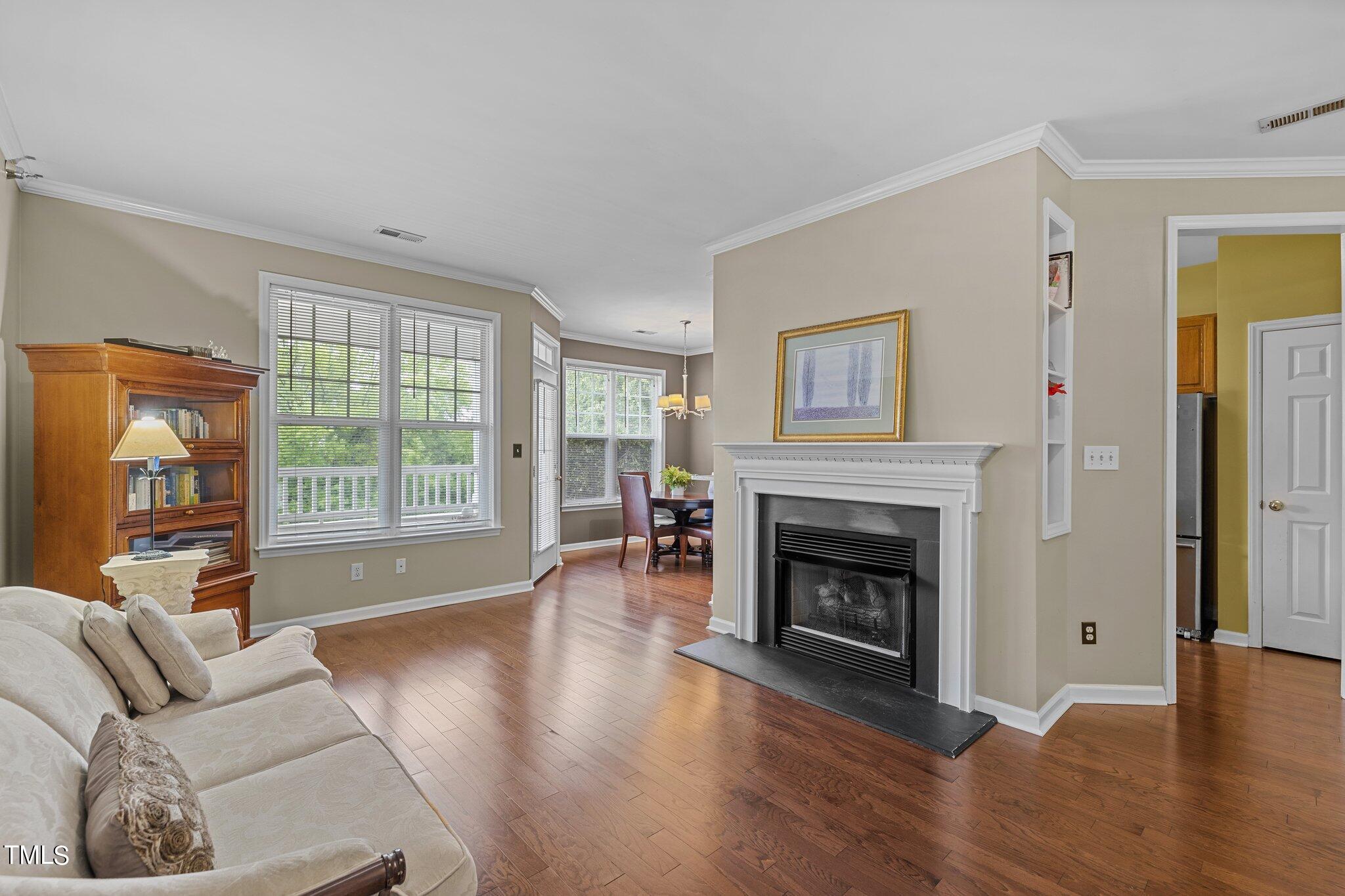 1710 Tiffany Bay Court, Unit 301 Raleigh, NC 27609 - Photo 4 of 36 a living room with furniture and a fireplace