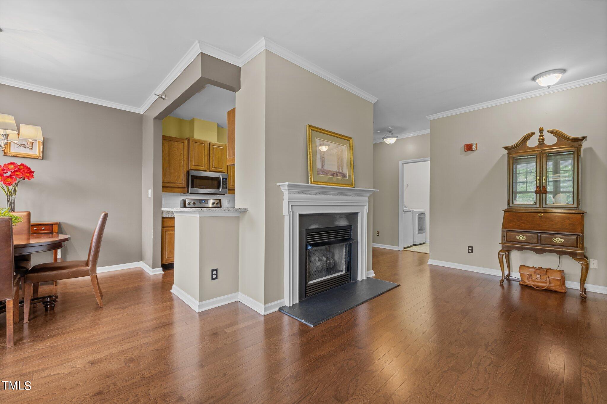 1710 Tiffany Bay Court, Unit 301 Raleigh, NC 27609 - Photo 6 of 36 a living room with furniture and a fireplace