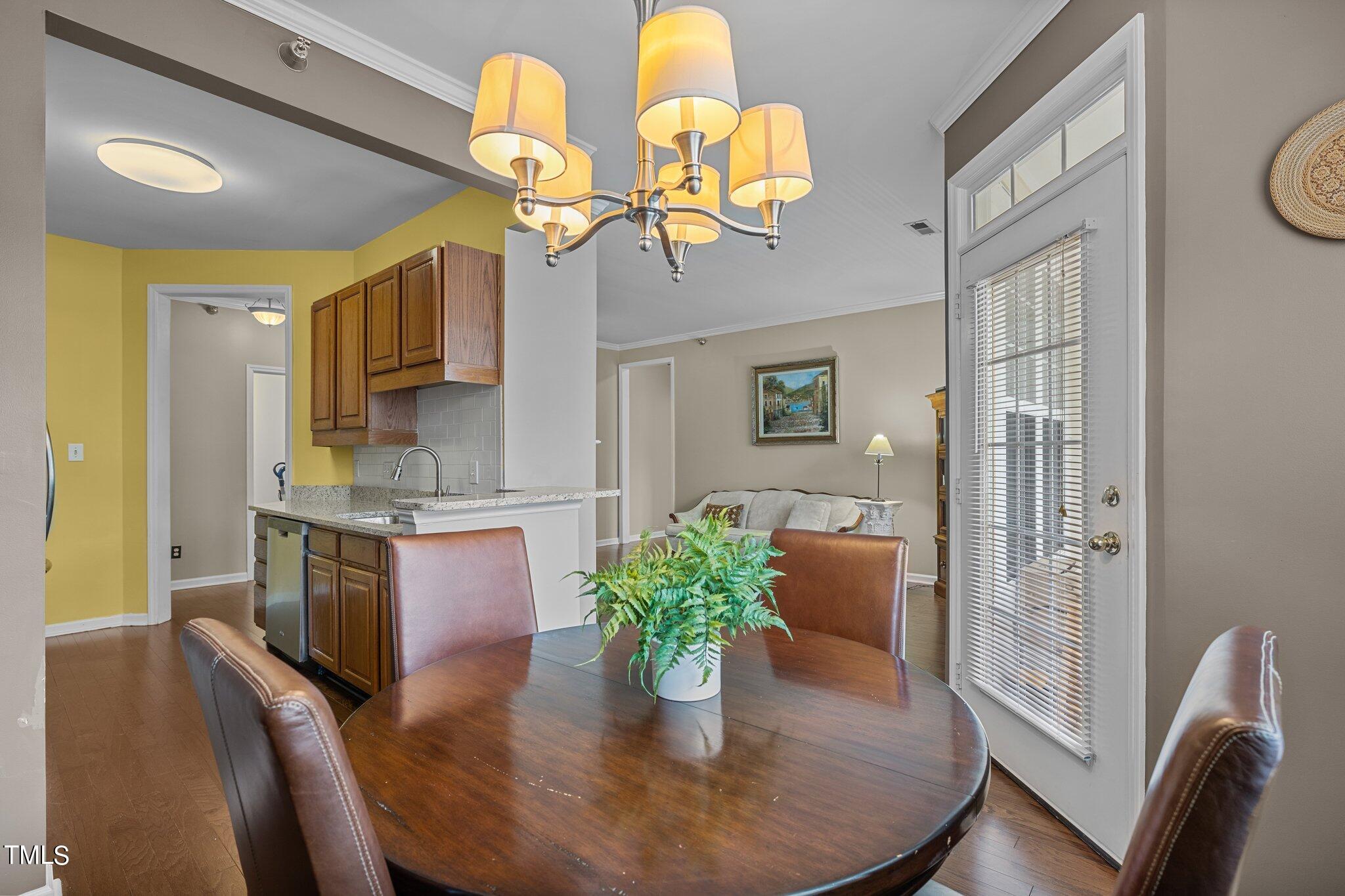 1710 Tiffany Bay Court, Unit 301 Raleigh, NC 27609 - Photo 10 of 36 a dining room with fireplace furniture and a chandelier