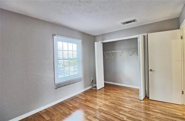 a view of house with river and trees in the background