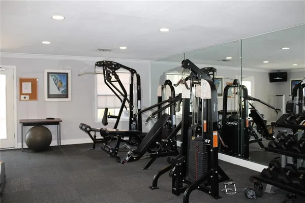 a room with gym equipment and a large window