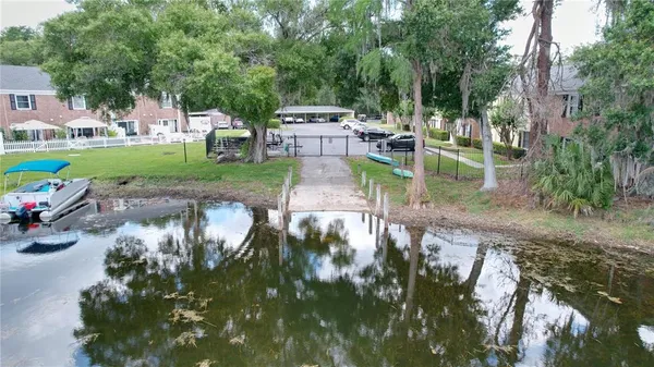 an aerial view of a residential houses with outdoor space and lake view