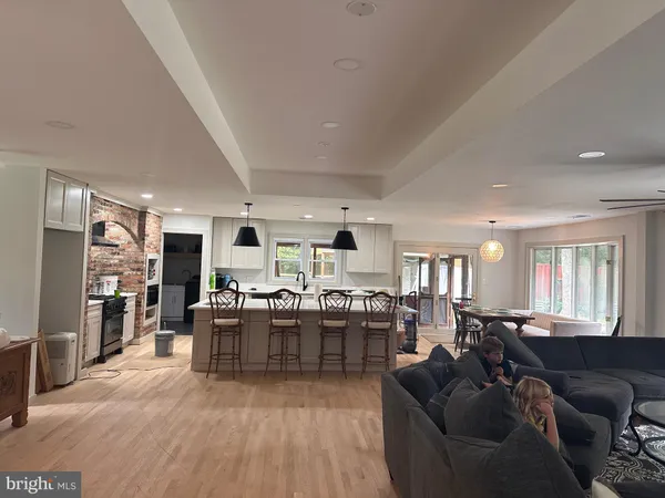 a living room with lots of furniture and kitchen view