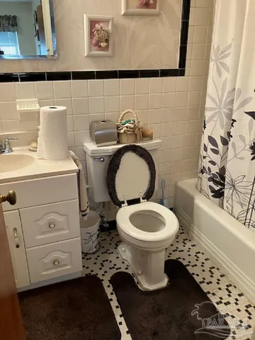 a bathroom with a toilet a sink and a mirror