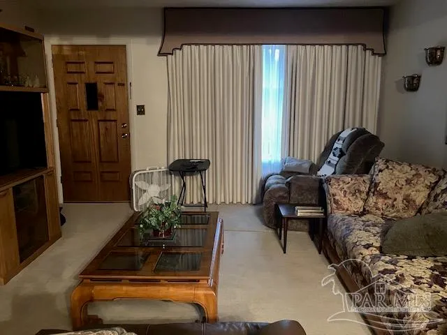 a living room with furniture gym equipment and a large window