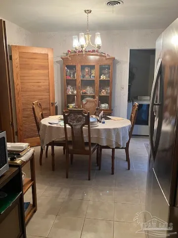 a view of a dining room with furniture and chandelier