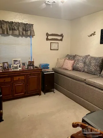 a living room with a couch and dresser
