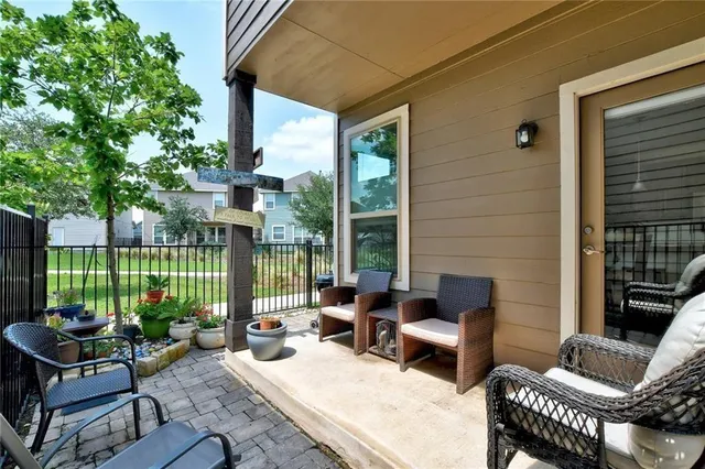 a view of a patio with couches chairs and a potted plant