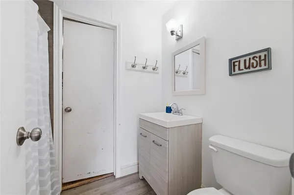 a white toilet sitting next to a bathroom sink