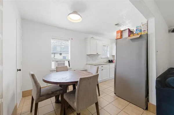 a view of a dining room with furniture and a kitchen