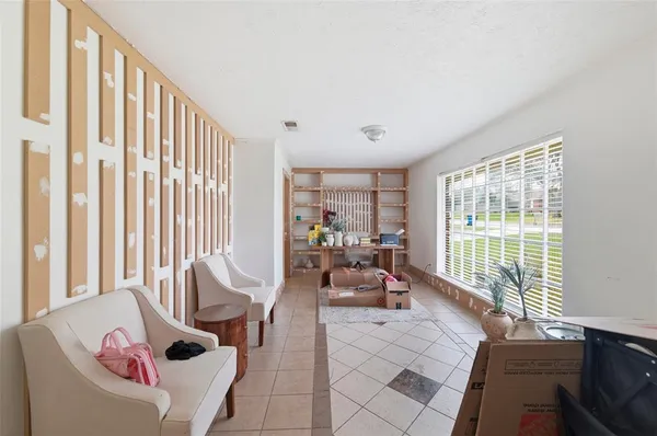 a living room with furniture and a large window