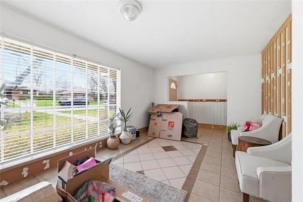 a bedroom with furniture and a large window
