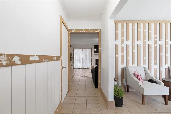 a hallway with table and chairs