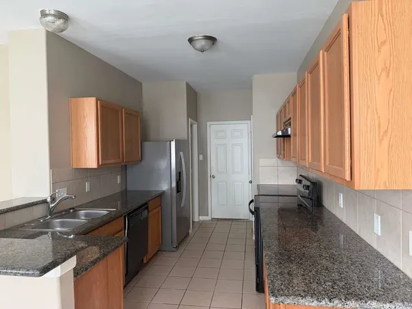 a kitchen with a sink stove and refrigerator