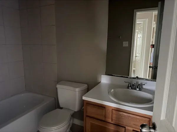 a bathroom with a toilet a sink and bathtub