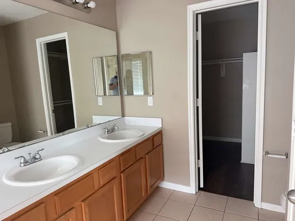 a bathroom with a double vanity sink and a mirror