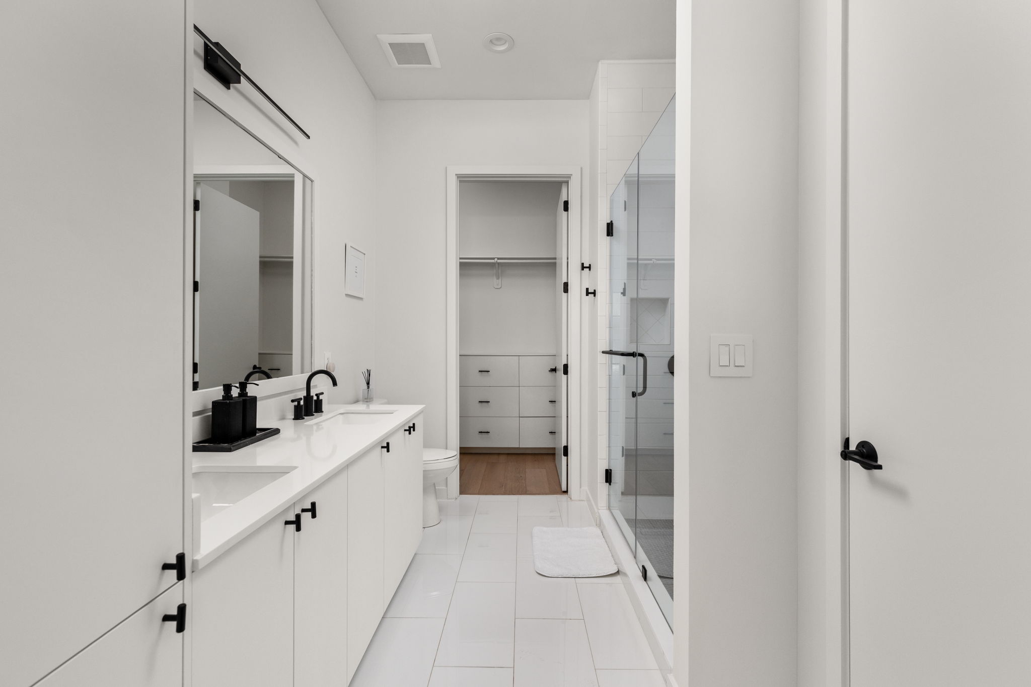 800 Embassy Drive, Unit 113 Austin, TX 78702 - Photo 13 of 36 a bathroom with a double vanity sink mirror and shower