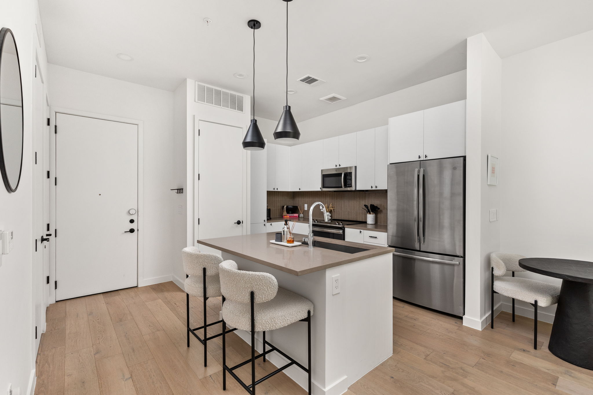 800 Embassy Drive, Unit 113 Austin, TX 78702 - Photo 5 of 36 a kitchen with stainless steel appliances a refrigerator sink and microwave