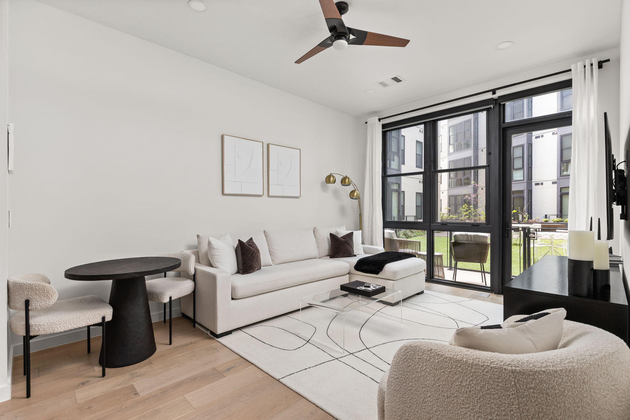 800 Embassy Drive, Unit 113 Austin, TX 78702 - Photo 6 of 36 a living room with furniture and floor to ceiling window