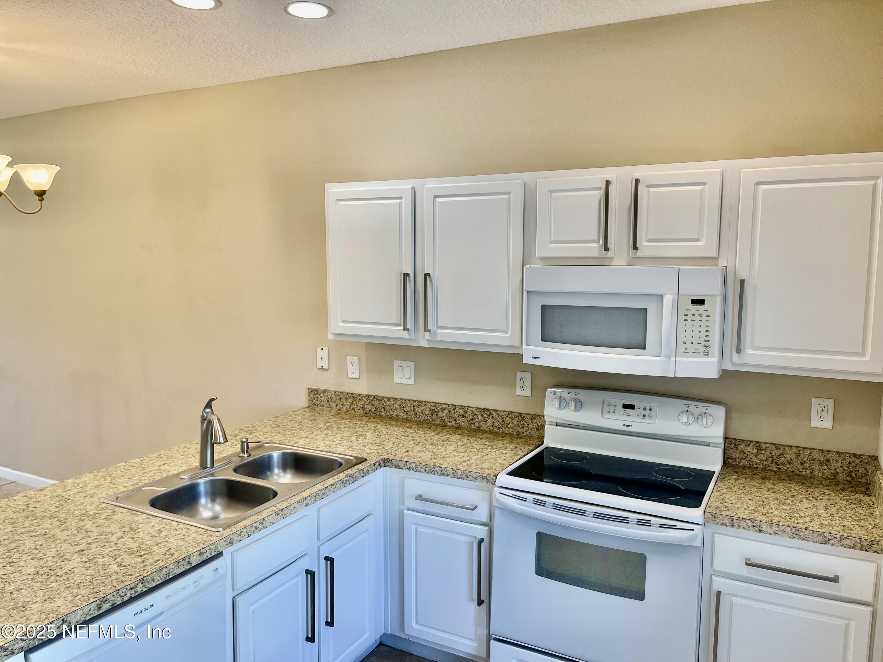 486 Cabernet Place St. Augustine, FL 32084 - Photo 2 of 29 a kitchen with granite countertop a sink and stove top oven
