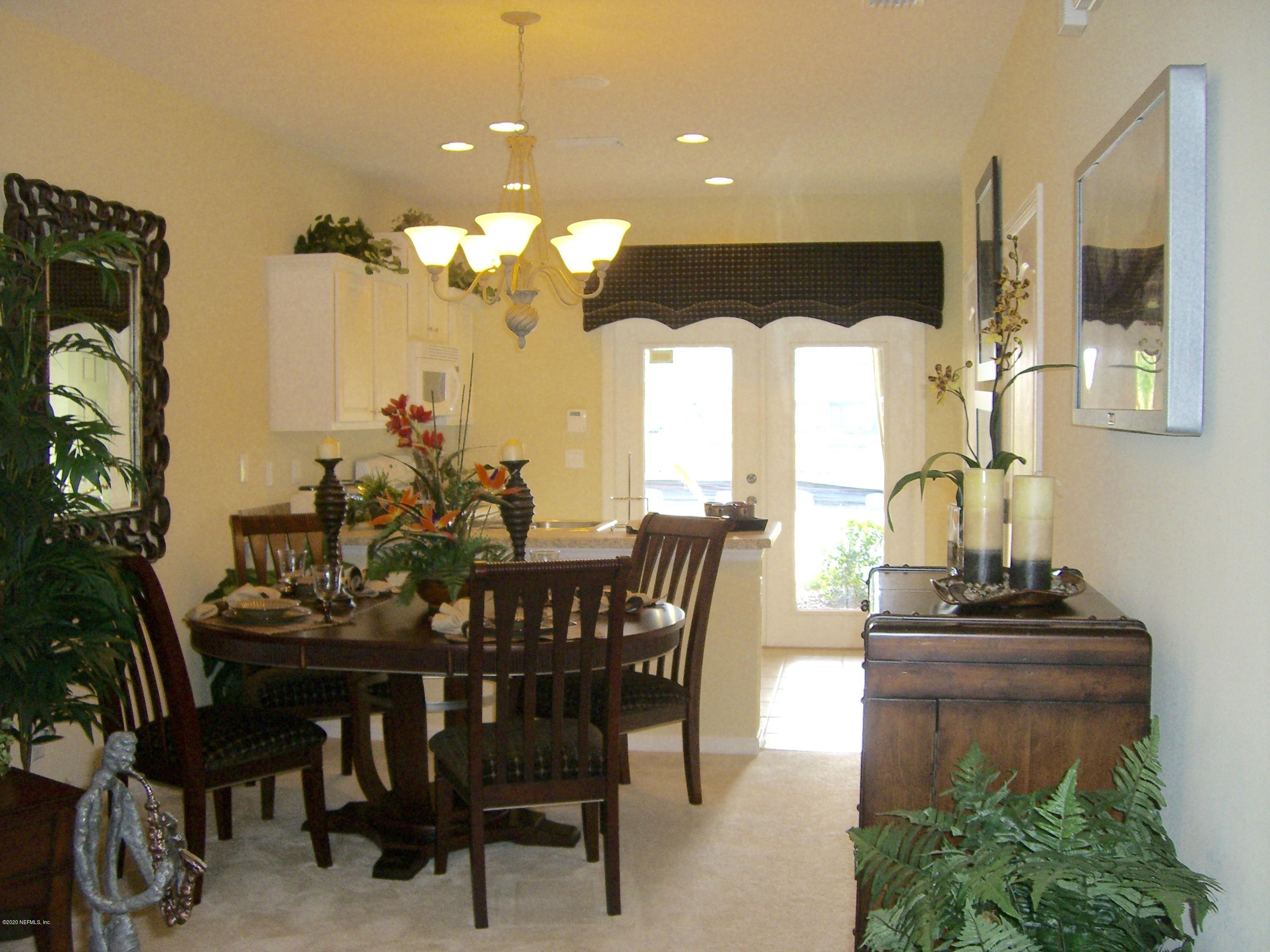 486 Cabernet Place St. Augustine, FL 32084 - Photo 24 of 29 a view of a dining room with furniture and chandelier