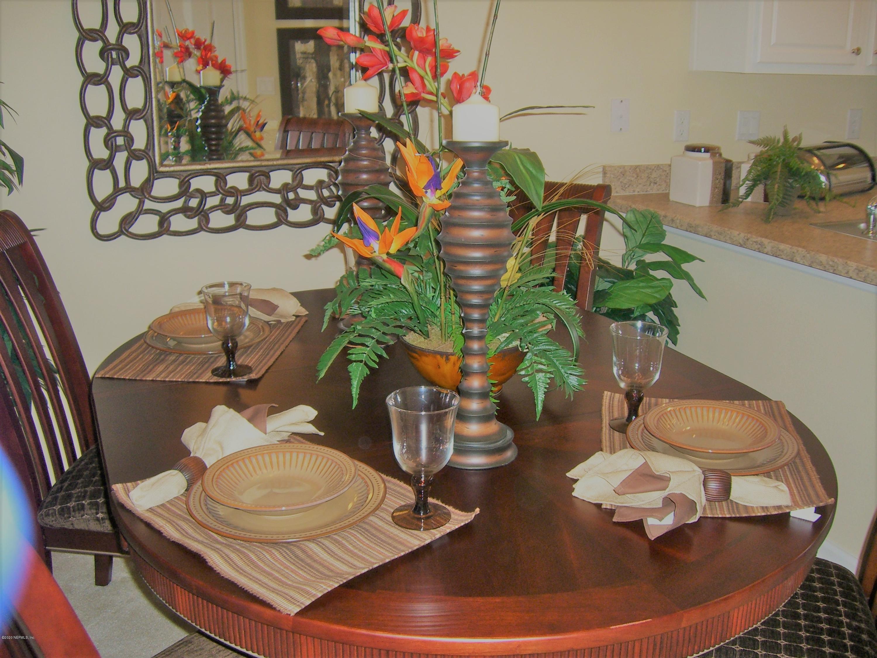 486 Cabernet Place St. Augustine, FL 32084 - Photo 27 of 29 a vase of flowers sitting on a dining table