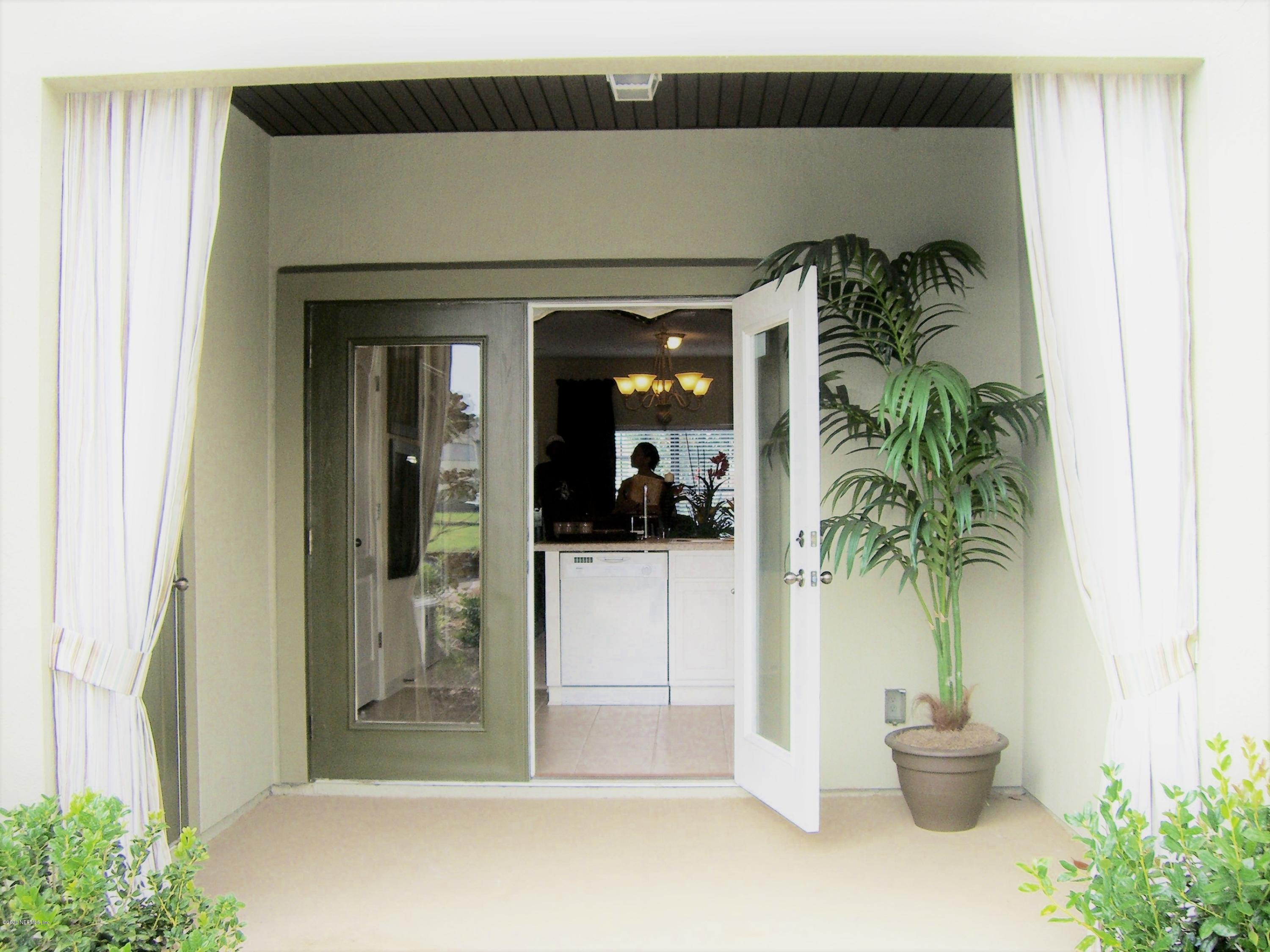 486 Cabernet Place St. Augustine, FL 32084 - Photo 29 of 29 a view of a hallway with potted plant in front of door