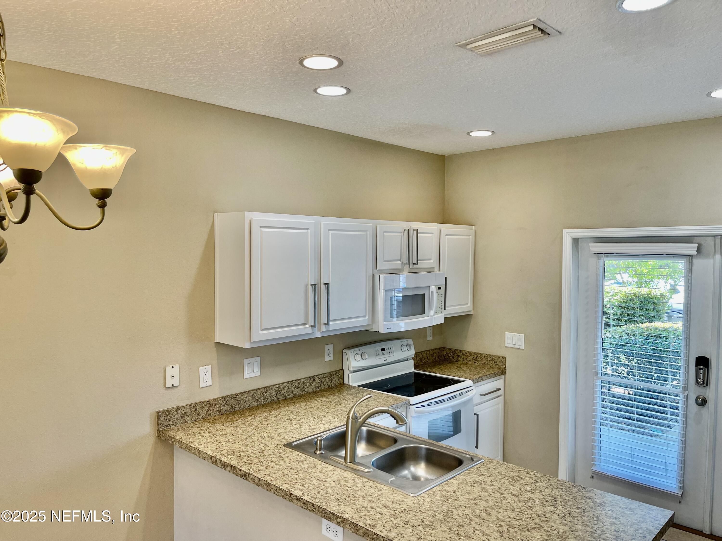 486 Cabernet Place St. Augustine, FL 32084 - Photo 5 of 29 a kitchen that has a lot of cabinets in it