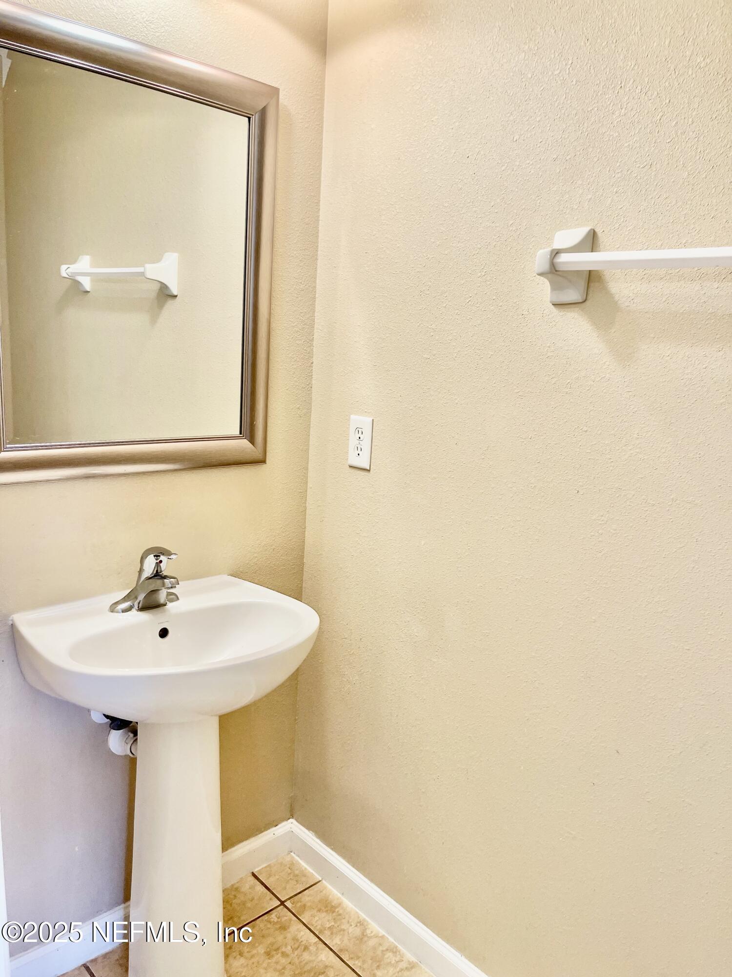 486 Cabernet Place St. Augustine, FL 32084 - Photo 7 of 29 a bathroom with a sink and mirror