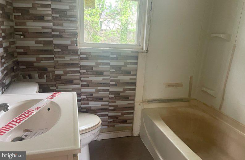 108 Price Road Chester, MD 21619 - Photo 8 of 10 a bathroom with a bathtub and window