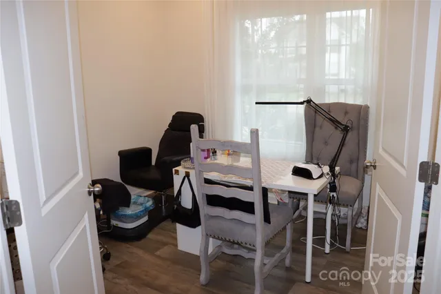 a room with a chair and white walls