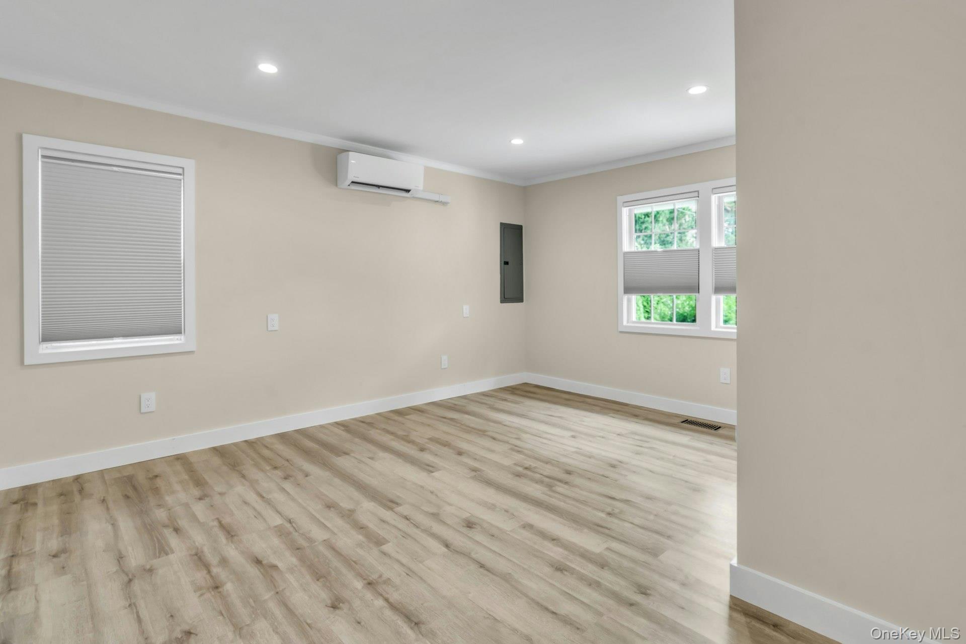 20 Robert Road Glen Cove, NY 11542 - Photo 9 of 23 Primary bedroom on the main floor with windows and blinds screens.