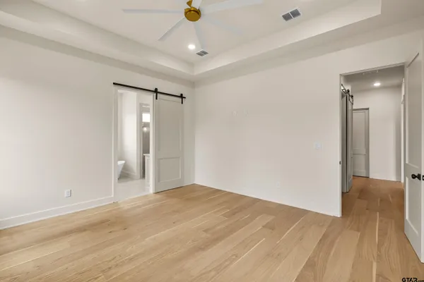 a white bath tub sitting next to a white sink and vanity