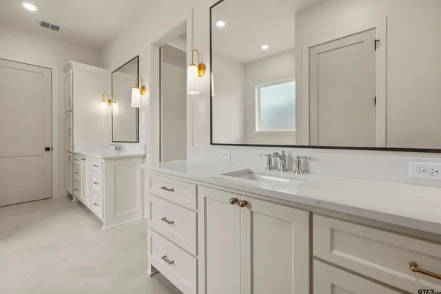 a bathroom with a double vanity sink mirror and double